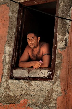 _MAN LOOKING OUT FROM WINDOW IN CENTRO HAVANA