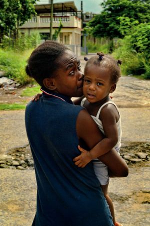 WOMAN WITH HER CHILD IN A BARRIO IN HAVANA